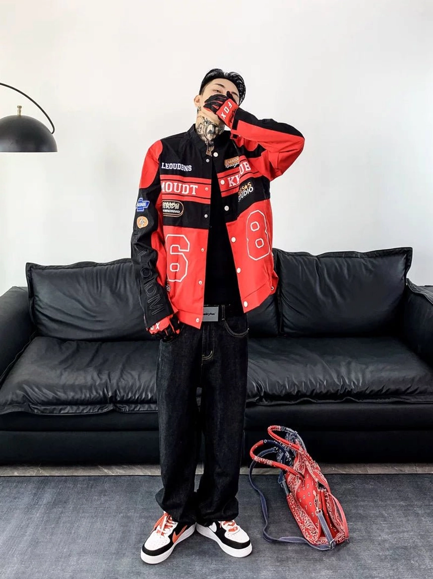 Red and black motorcycle racing varsity jacket styled with dark jeans and matching red black streetwear sneakers