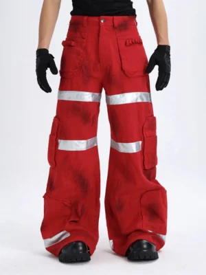 Red and black washed tie-dye reflective cargo pants with oversized wide-leg fit utility pockets and silver bands
