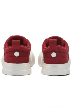 Rear view of red burgundy canvas low-top sneakers showing white chunky midsoles, heel pull tabs, and circular decorative heel buttons