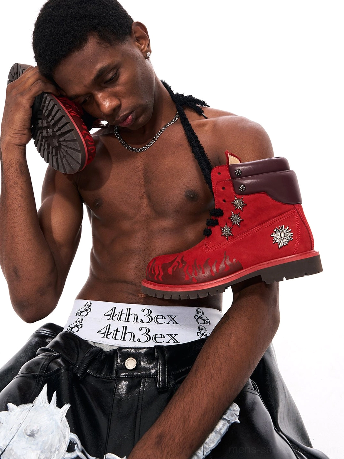 Close-up of red flame appliqué genuine leather combat boot with padded collar and studded hardware