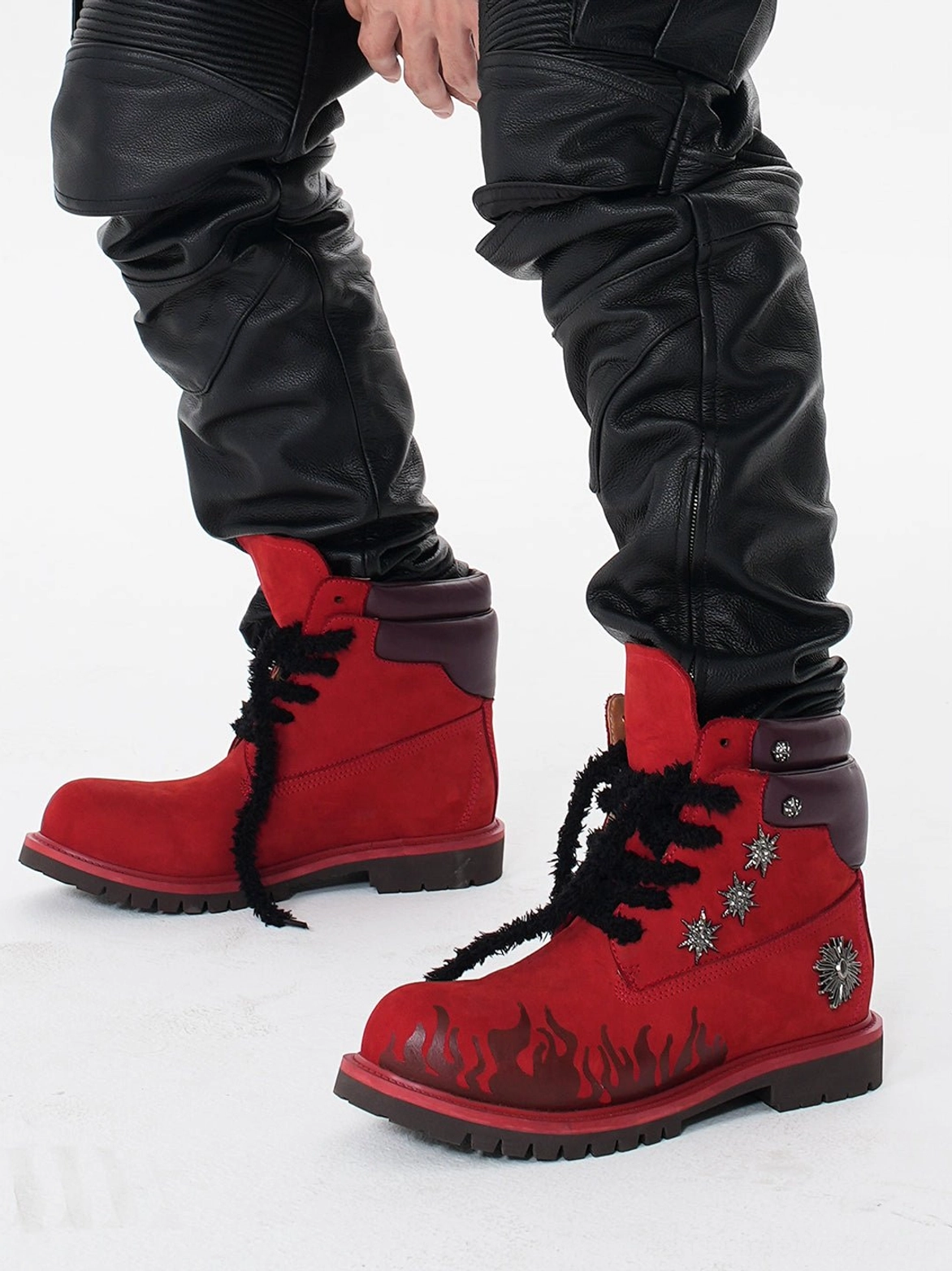 Male model wearing red flame appliqué genuine leather combat boots with black leather cargo pants