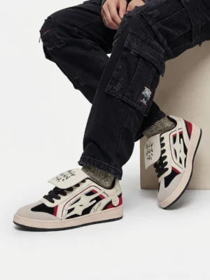 Red flame panel retro trainer sneakers worn with black cargo pants in a low-angle streetwear outfit view