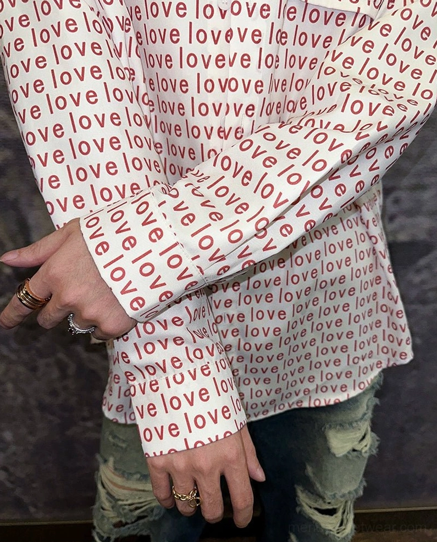 Detailed sleeve and hem view of relaxed fit red love typography button-up shirt with streetwear accessories