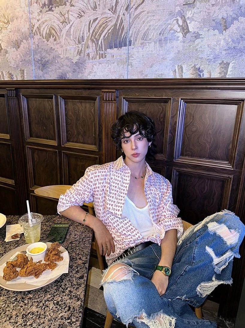 Red love typography button-up shirt in relaxed Korean streetwear outfit with ripped blue jeans