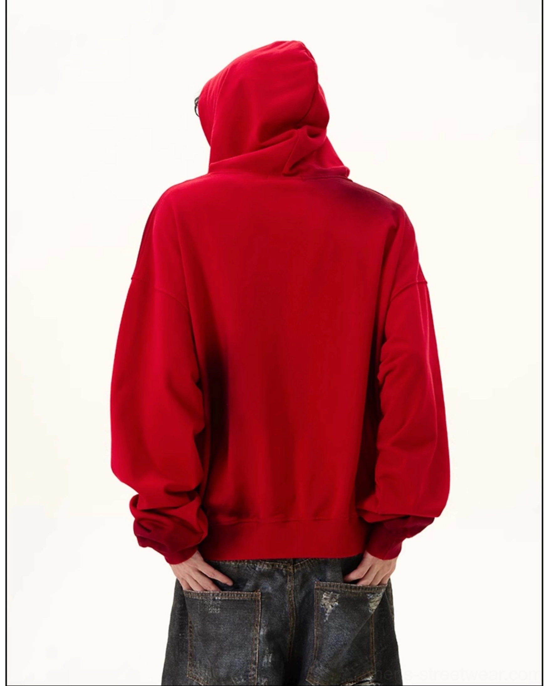 Rear view of solid red oversized hoodie showing clean back panel, attached hood, ribbed cuffs, ribbed hem, and relaxed streetwear silhouette