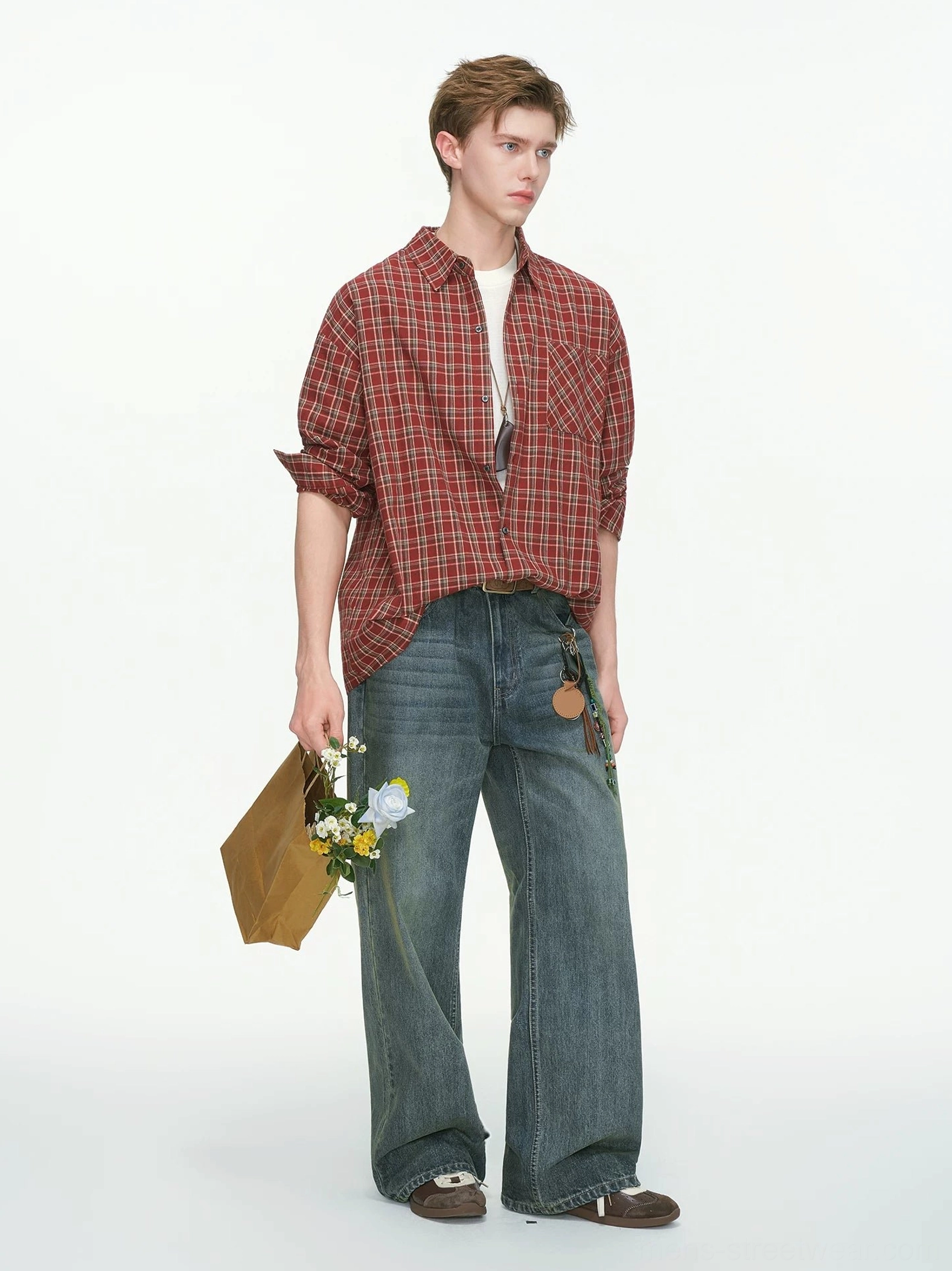 Red oversized plaid shirt with rolled sleeves styled with wide-leg jeans for a relaxed casual streetwear look