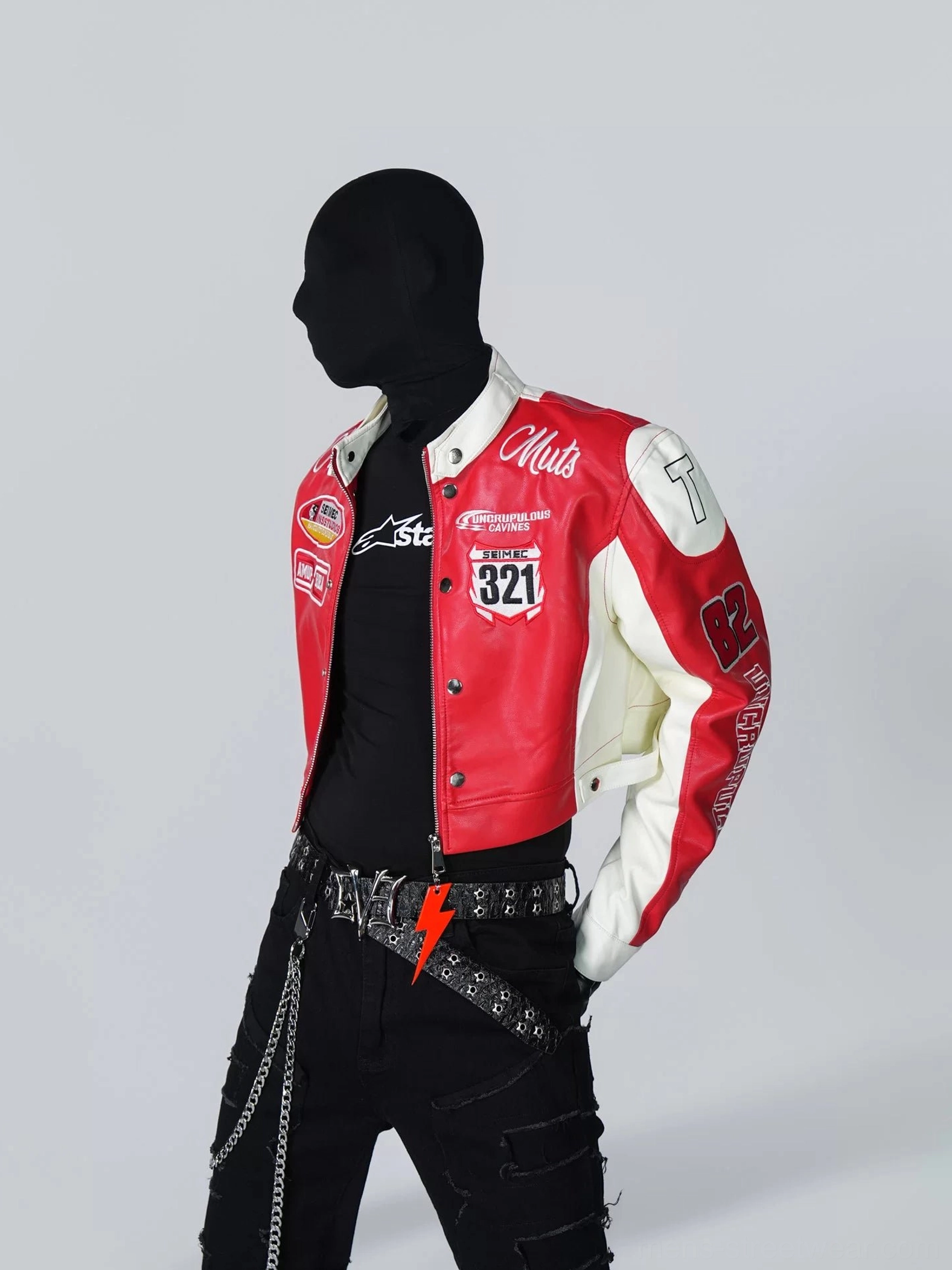 Three-quarter view of a red and white cropped motorcycle racing jacket with stand collar, zipper closure, snap details, 321 chest patch, and Korean-inspired streetwear styling