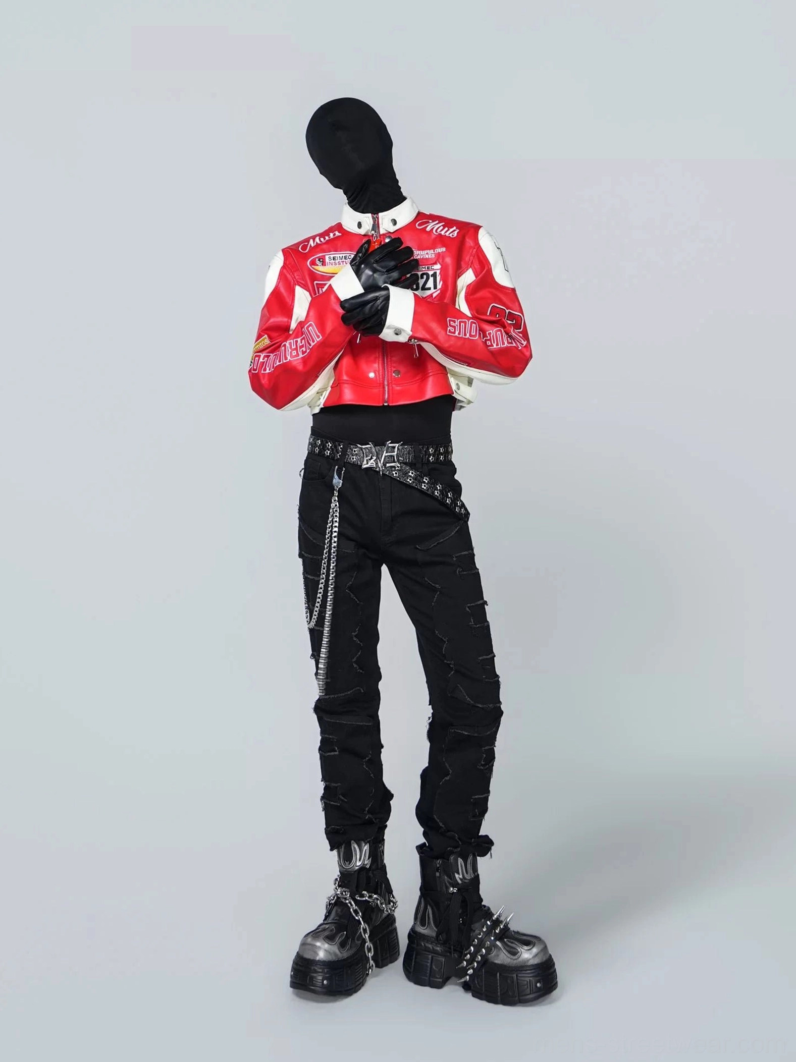 Front view of a bold red and white cropped PU leather racing jacket covered with motorsport patches, stand collar, black gloves, chain belt, and platform boots