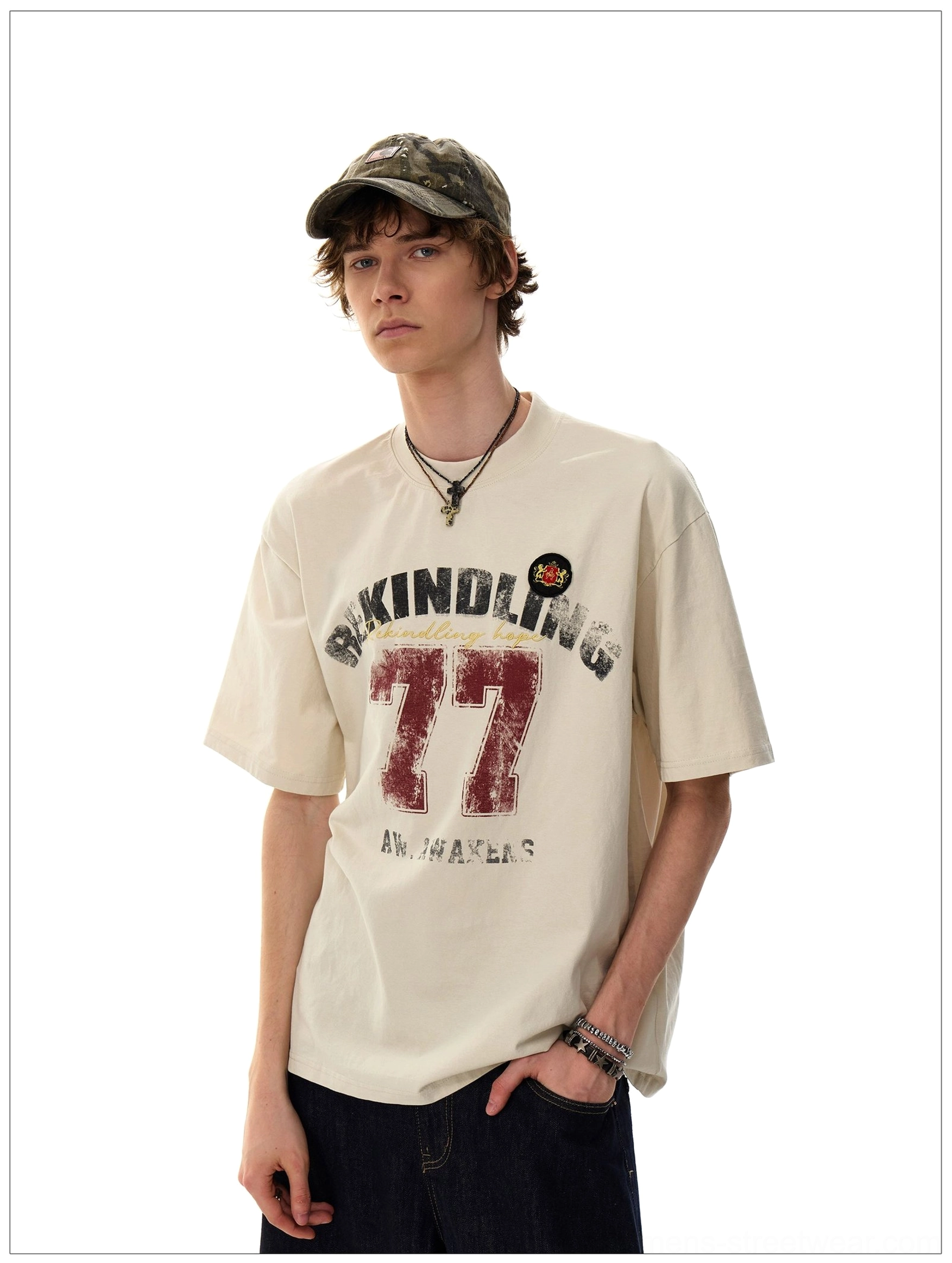 Close front view of the Apricot Rekindling 77 distressed graphic oversized T-shirt with necklace and bracelet accessories