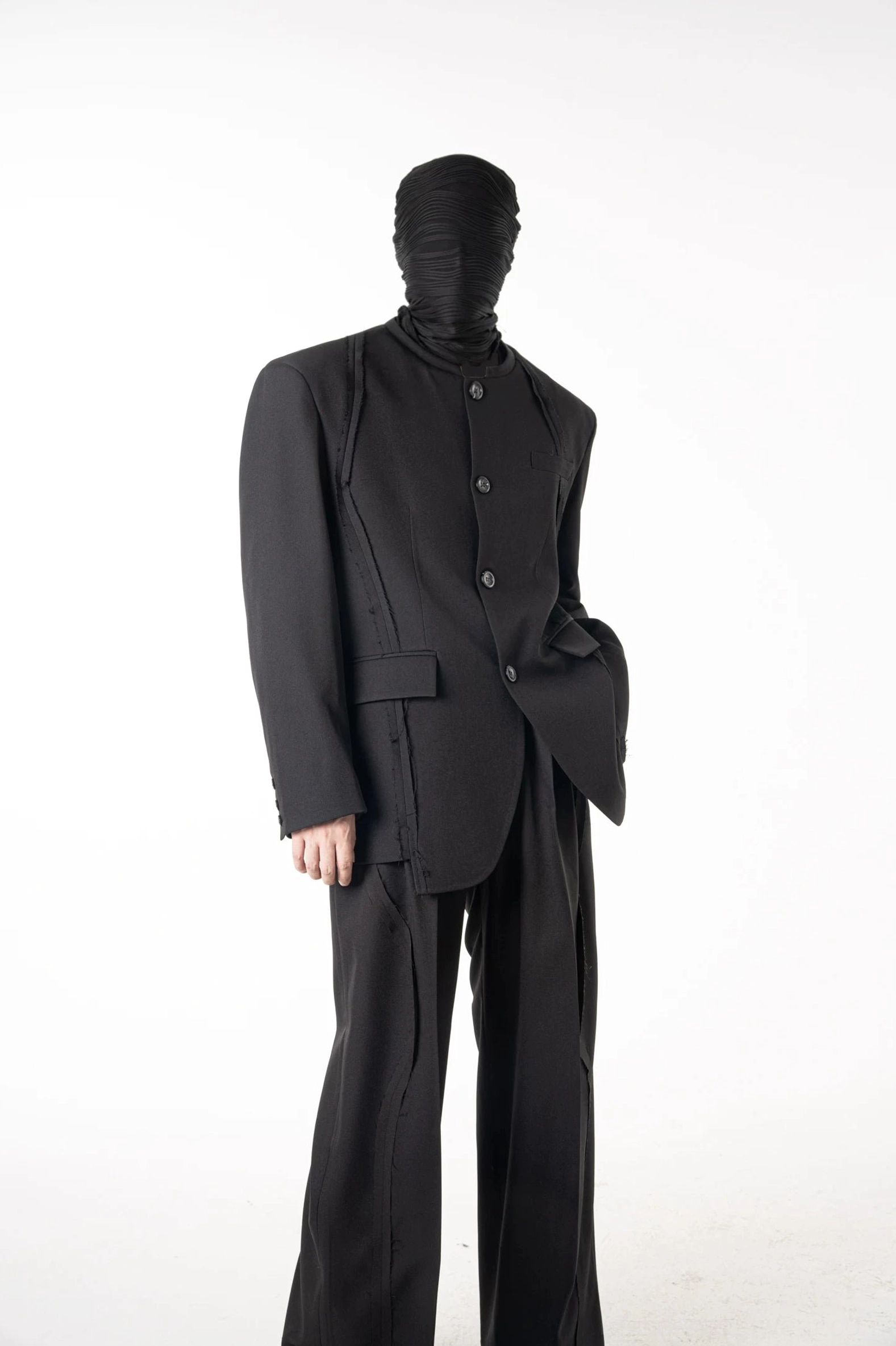 Side view of relaxed fit black blazer and matching wide-leg trousers in minimalist East Asian streetwear style