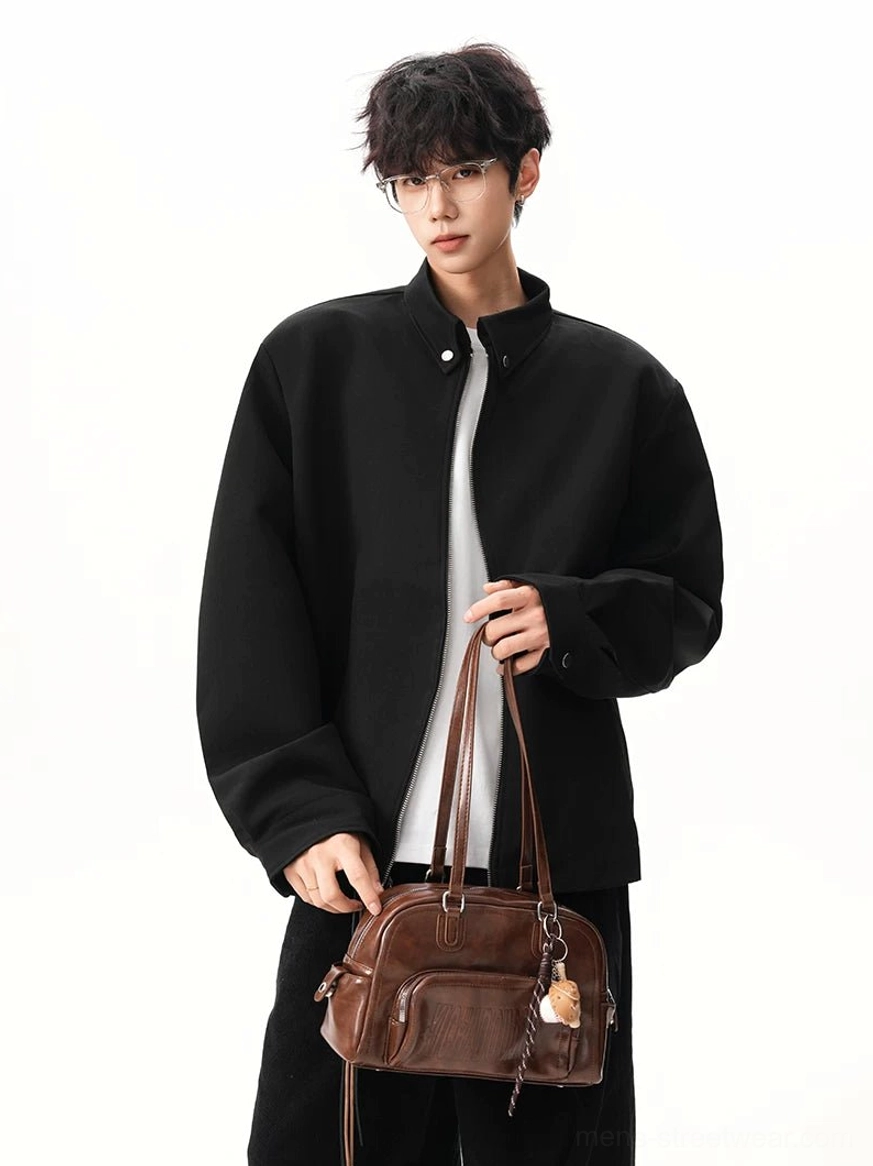 Relaxed black stand collar zip jacket styled as a minimalist Korean fashion outerwear layer with leather tote