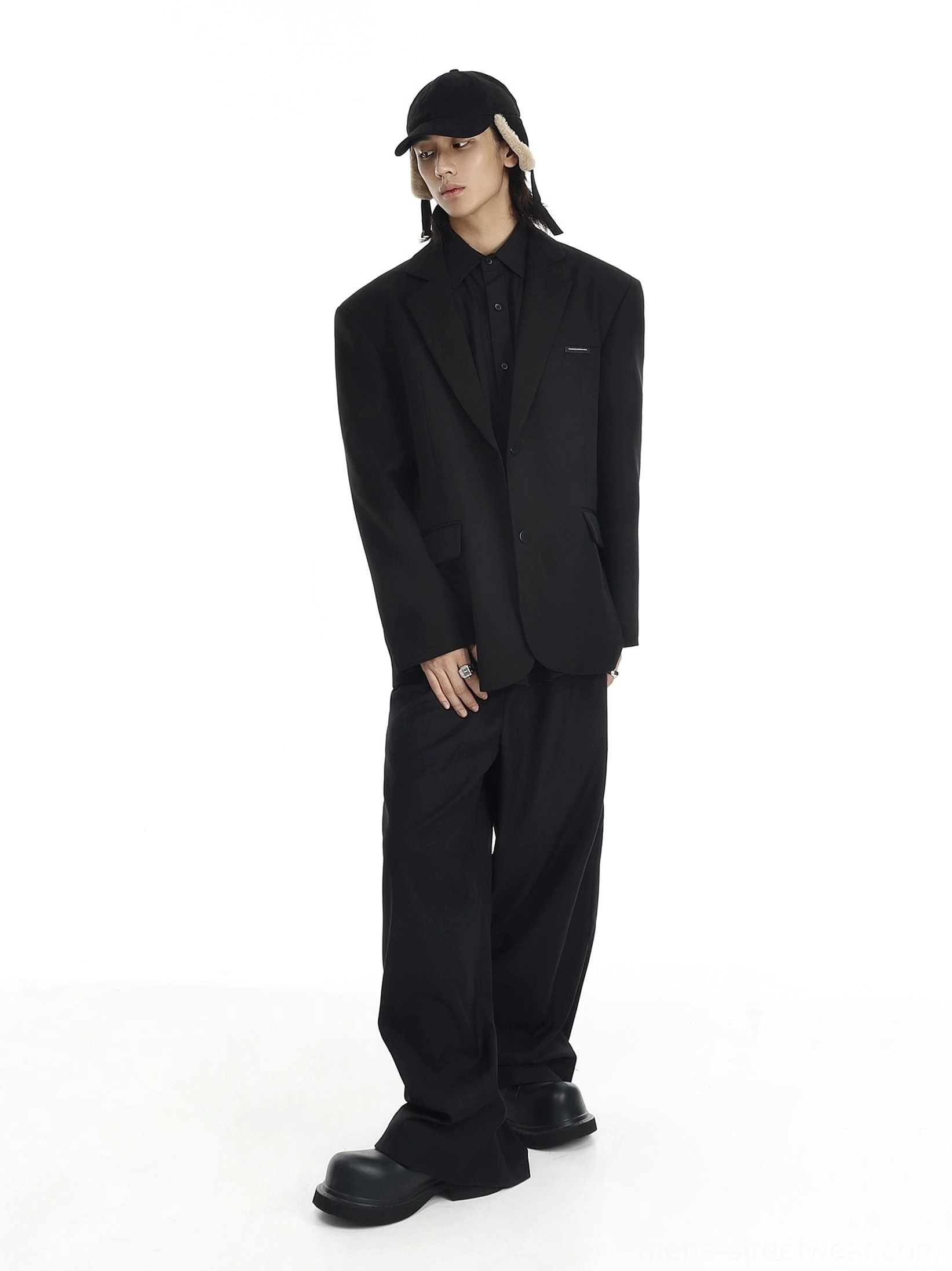 Relaxed black two-button blazer with wide-leg trousers and platform shoes, Korean streetwear side angle