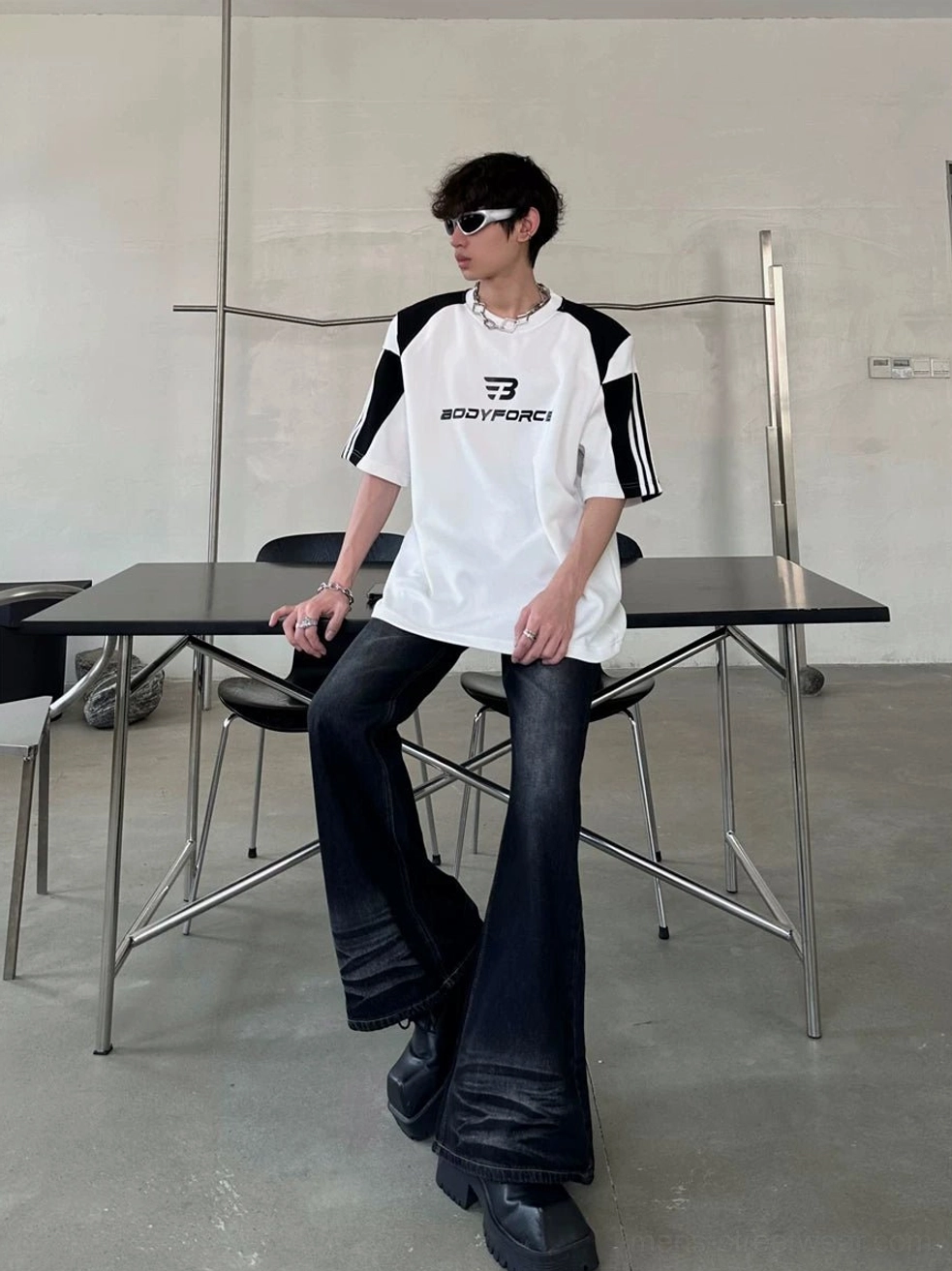 Relaxed colorblock athletic tee styled with dark flared jeans for a modern Seoul streetwear outfit