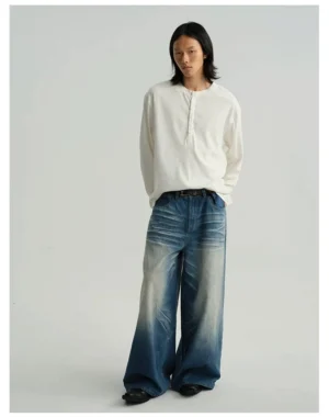 Off-white relaxed fit long sleeve Henley tee styled with wide-leg faded blue denim in a minimal streetwear outfit