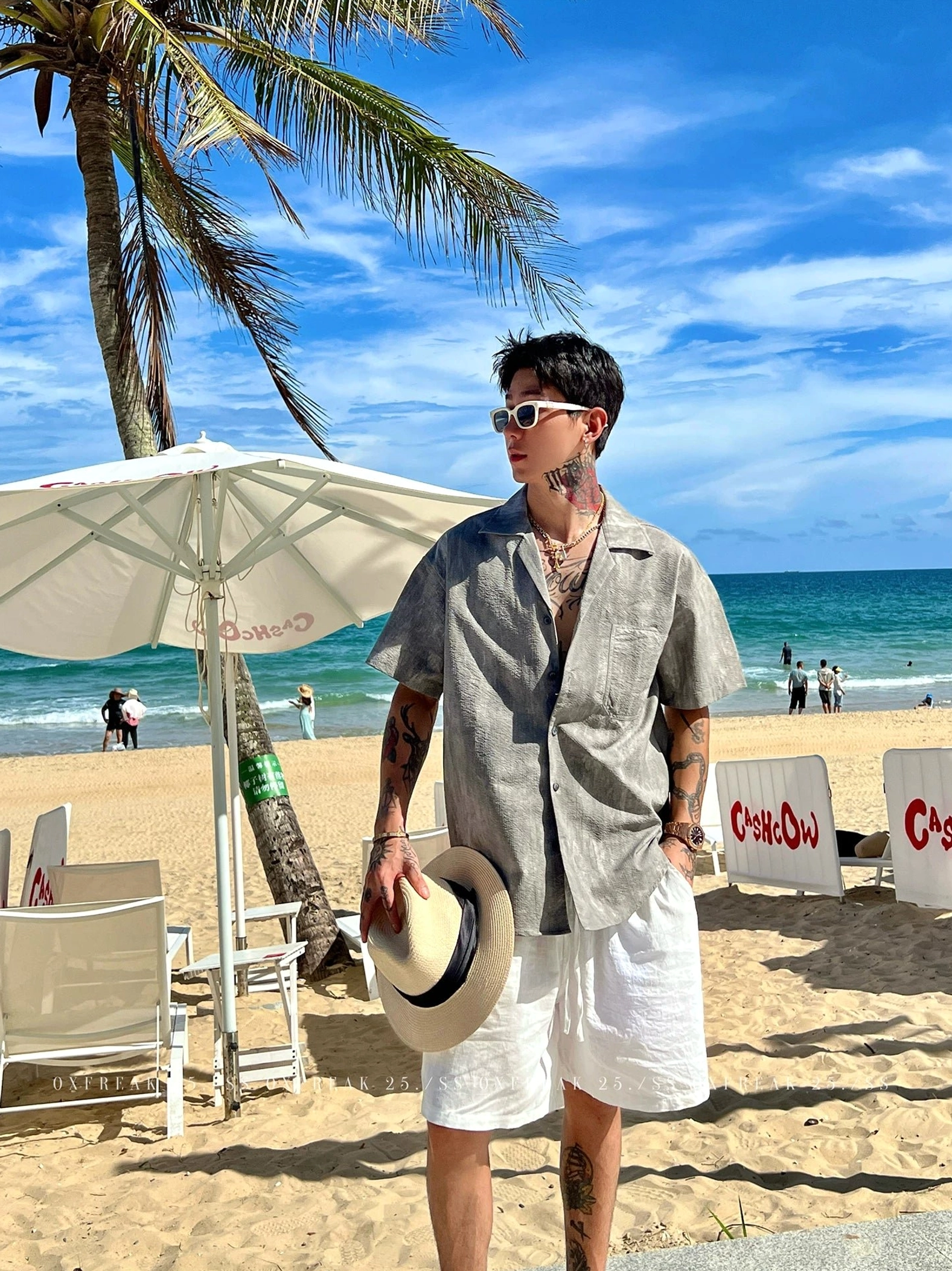 Relaxed Cuban collar short sleeve streetwear shirt styled with white shorts and a straw hat in a beach lounge setting