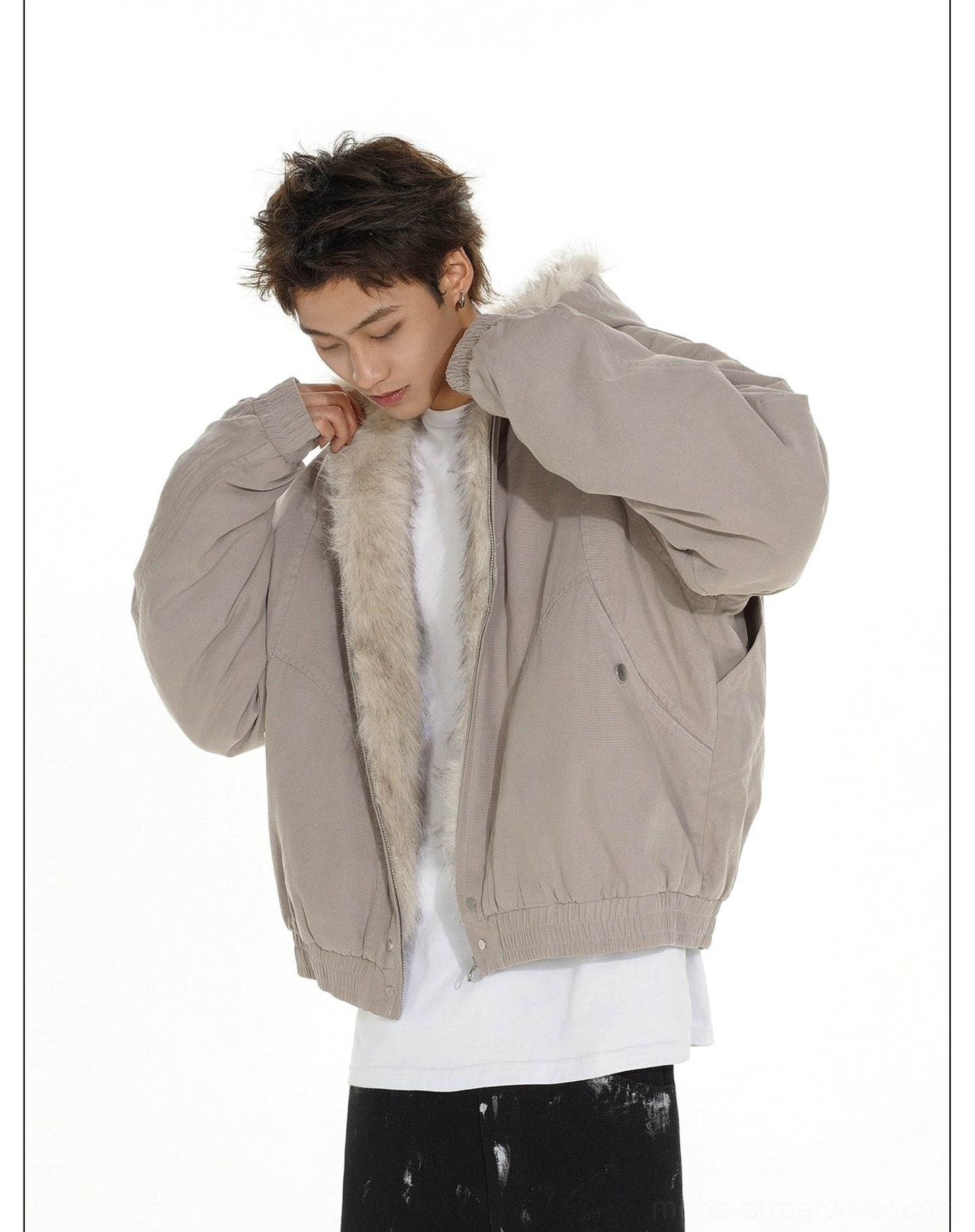 Relaxed faux fur lined bomber jacket design with cotton outer shell, snap front, and elasticated hem