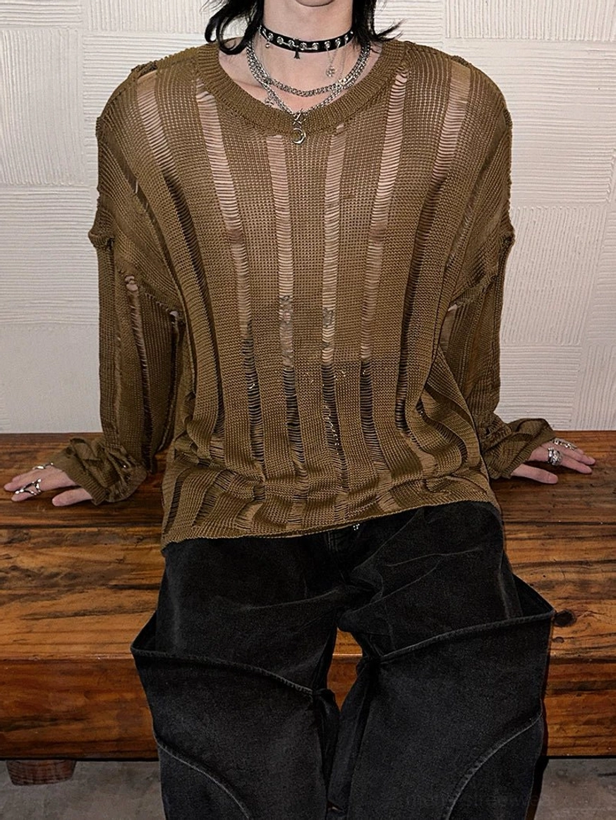 Seated front side view of a relaxed fit distressed sheer knit sweater with oversized sleeves and earthy brown yellow vertical laddering