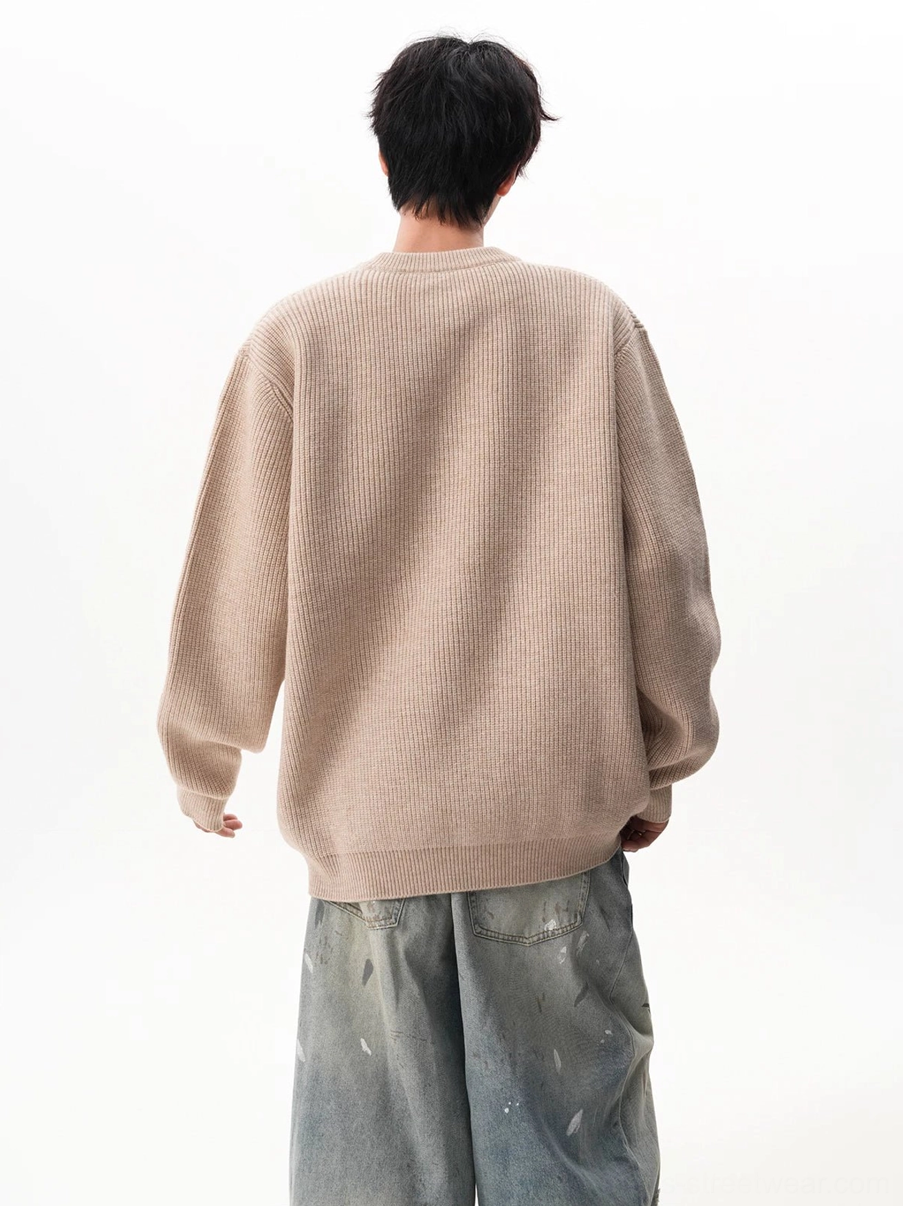 Relaxed fit waffle Henley sweater with three-button placket, wide sleeves, and textured ribbed knit construction