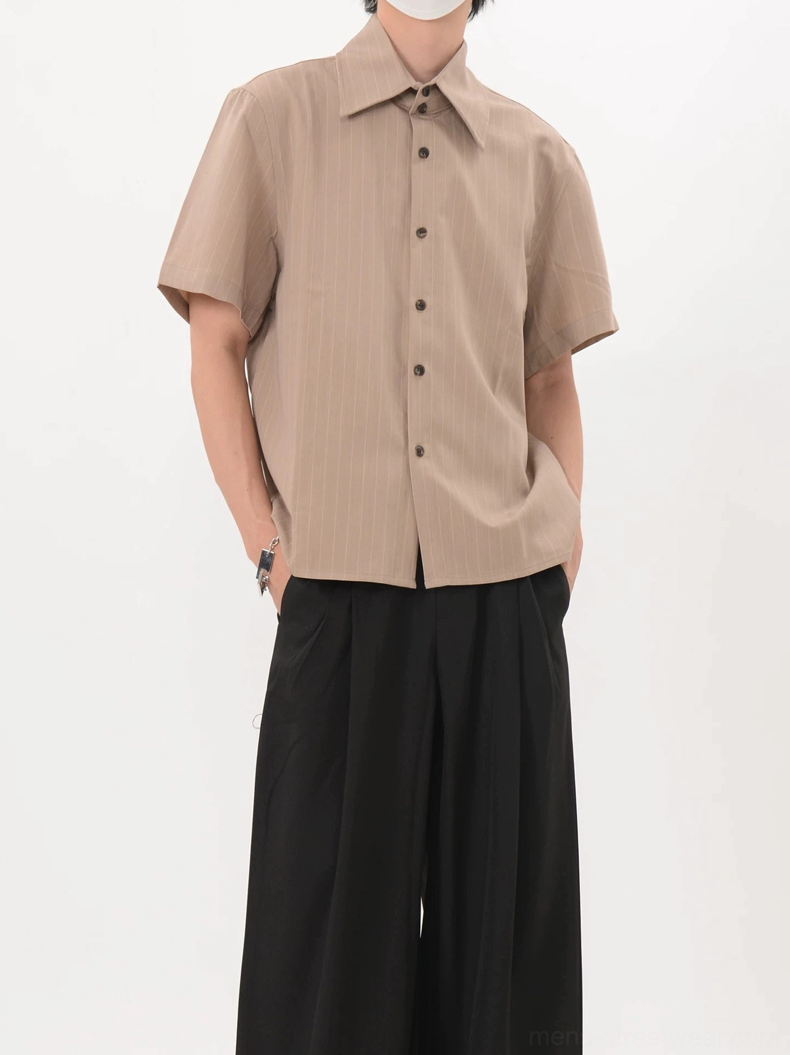 Relaxed khaki pinstripe shirt with pointed collar short sleeves and dark buttons shown from a right front angle