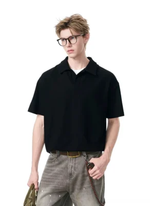Black relaxed knit polo shirt styled with gray jeans and a shoulder bag in a modern Seoul streetwear outfit