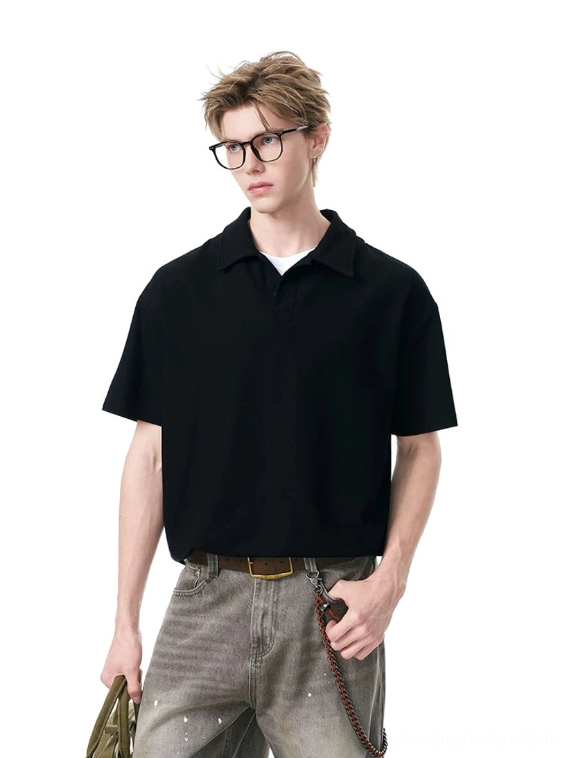 Black relaxed knit polo shirt styled with gray jeans and a shoulder bag in a modern Seoul streetwear outfit