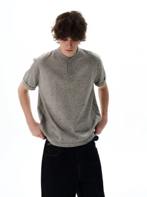 Heather grey relaxed knit short sleeve Henley shirt with rolled sleeves and three-button stand collar front view