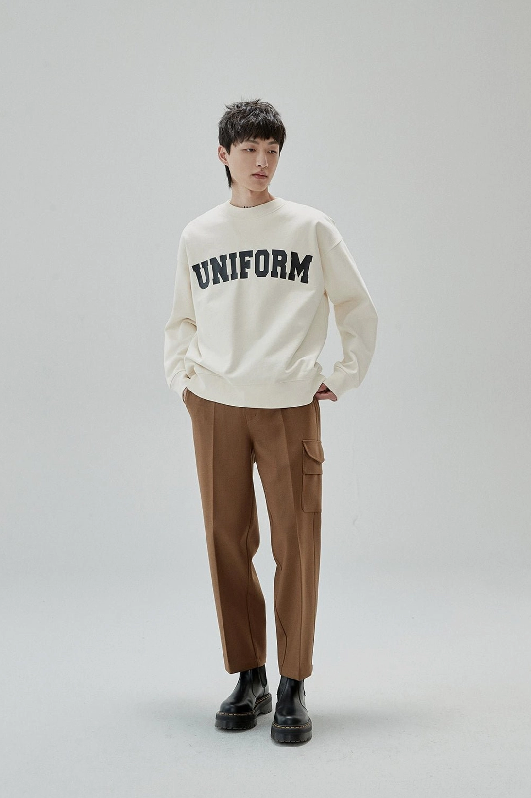 Relaxed Korean street fashion sweatshirt with bold arched lettering and classic crew neckline