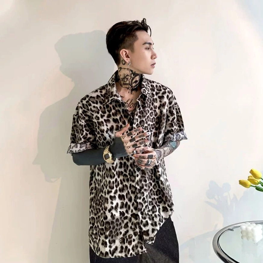Side profile of a male model wearing a casual loose leopard print short-sleeve satin shirt with a relaxed Korean fashion silhouette