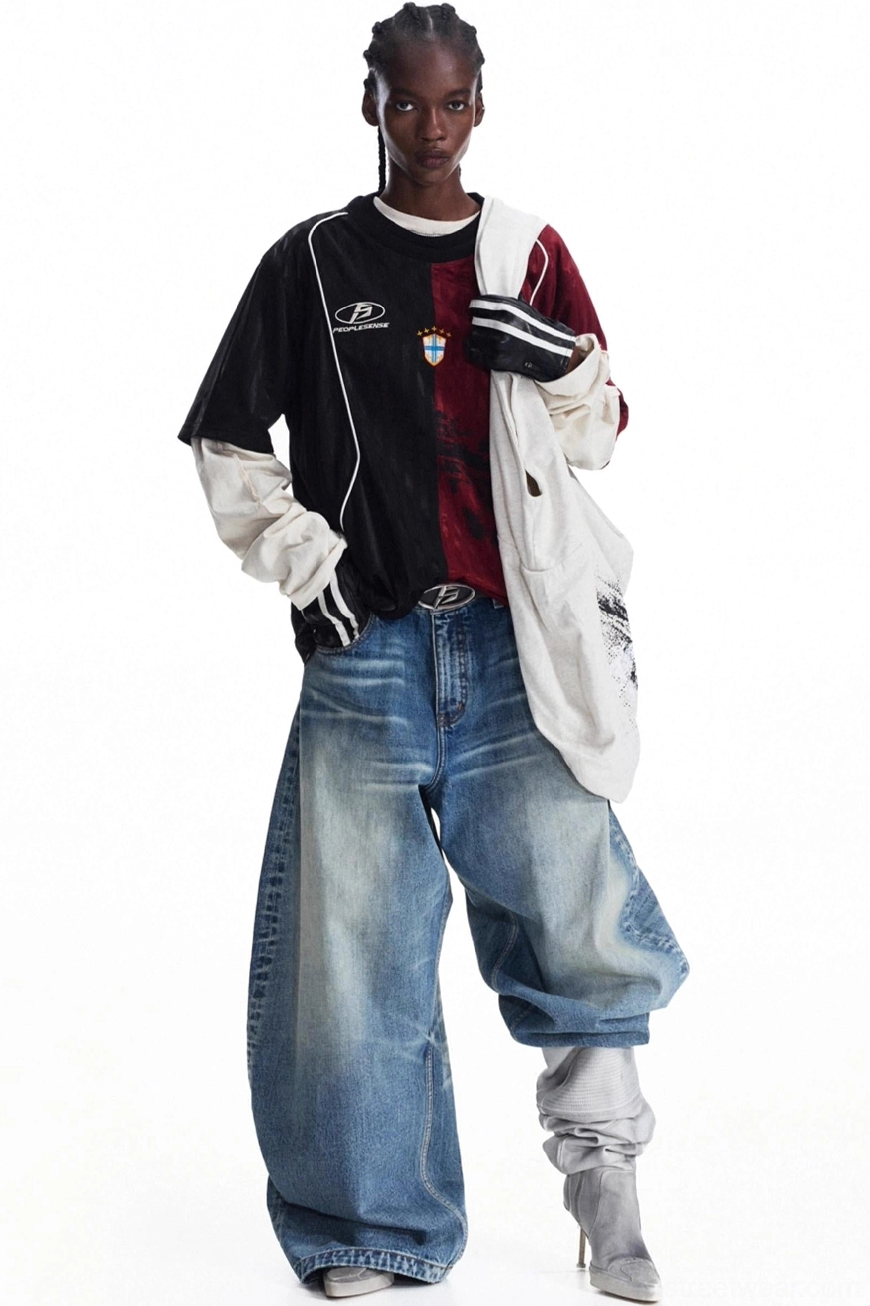 Relaxed oversized canvas shoulder tote bag with vintage distressed graphic print worn with sporty streetwear layers