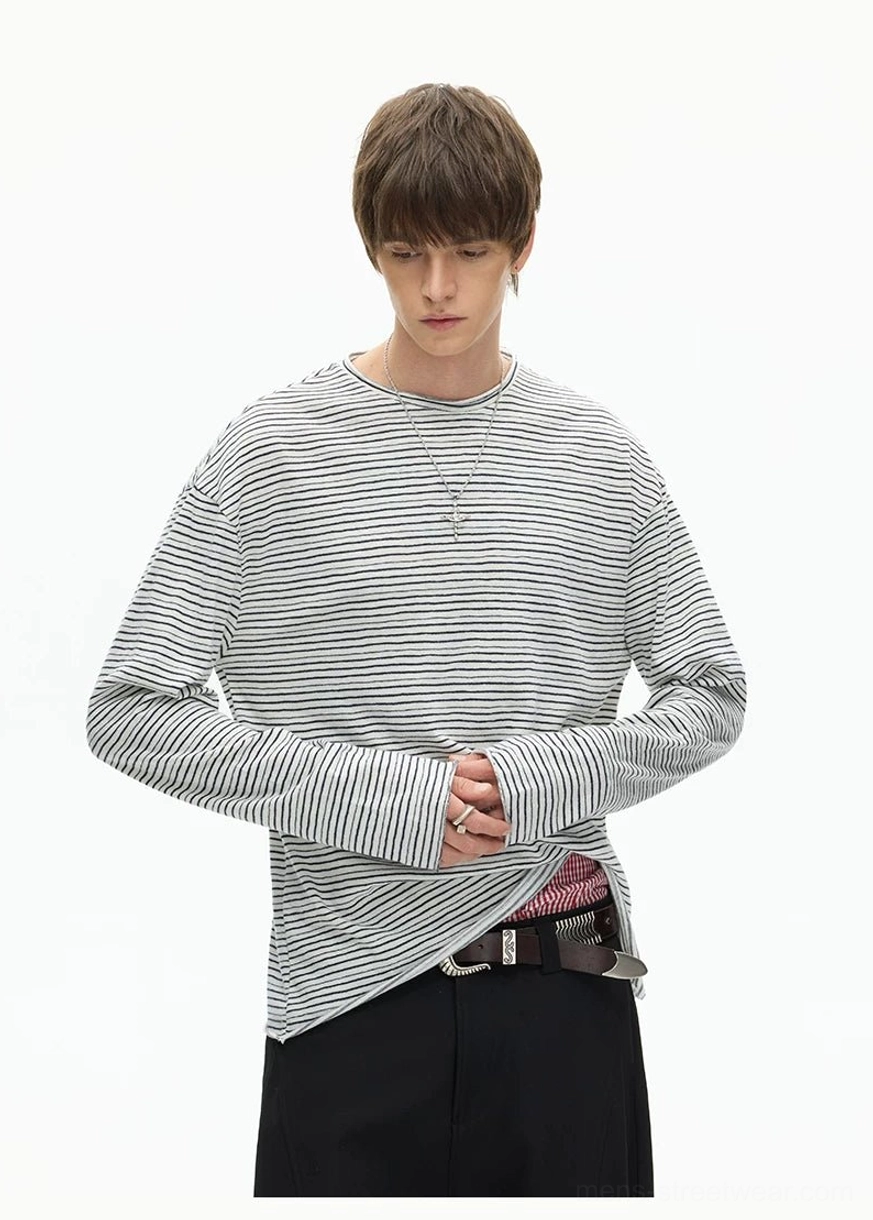 Relaxed striped long sleeve streetwear T-shirt with drop shoulders, exposed inner hem, and loose layered silhouette