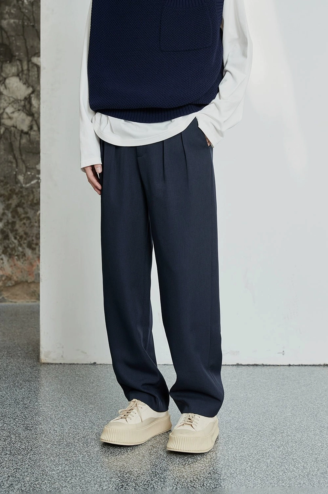 Relaxed tailored streetwear pants with adjustable drawstring leg opening and front pleats