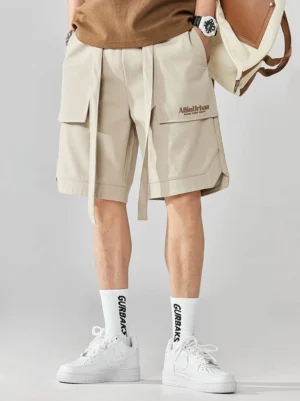 Front view of light beige relaxed techwear cargo shorts with oversized side pockets adjustable drawstring waist and straight-leg streetwear fit