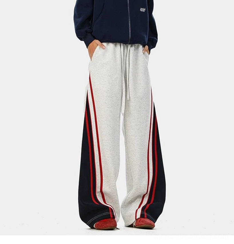 Relaxed varsity-style track pants with extra-long wide legs and contrast side stripe accents for sneaker styling
