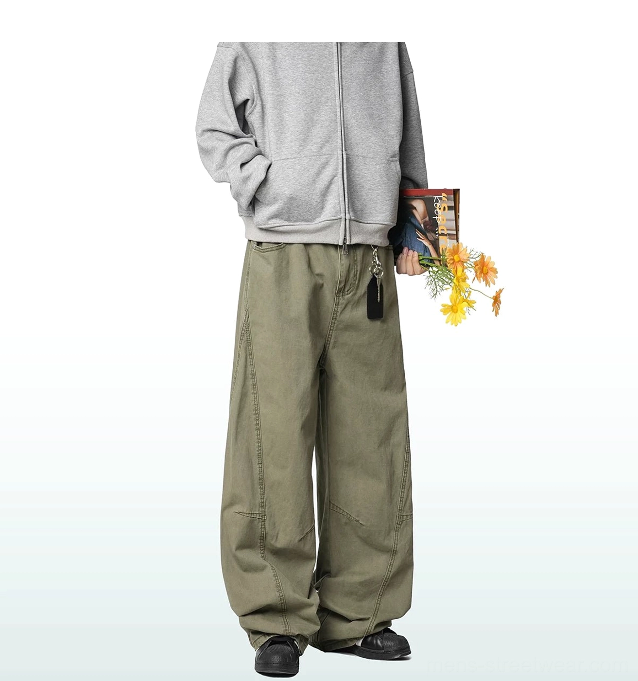 Relaxed wide-leg cargo trousers in a modern streetwear outfit, highlighting the low-rise shape, clean waistband and structured panel construction