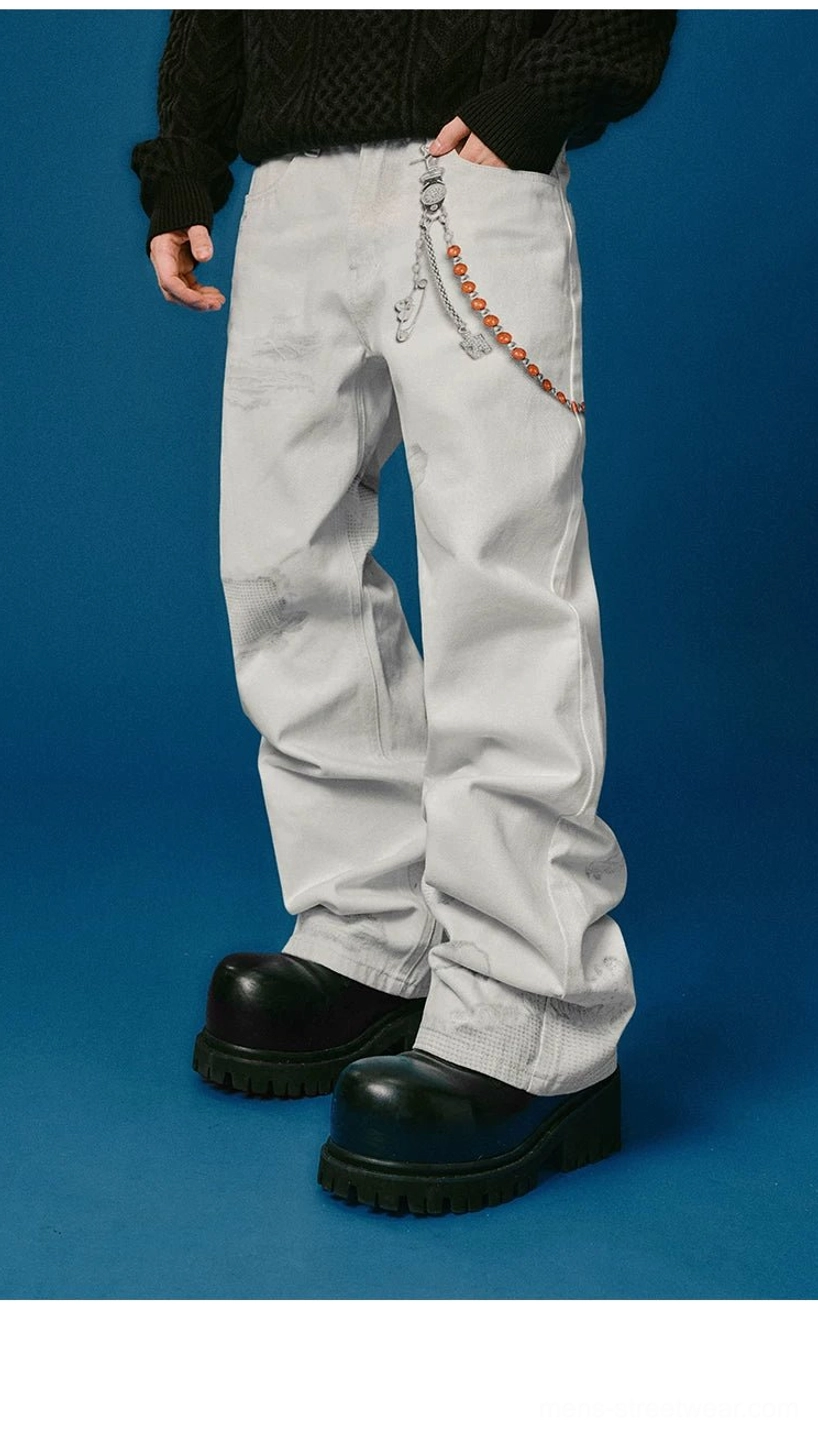 Relaxed wide-leg distressed denim jeans with decorative waist chain, vintage wash, and punk-inspired streetwear styling