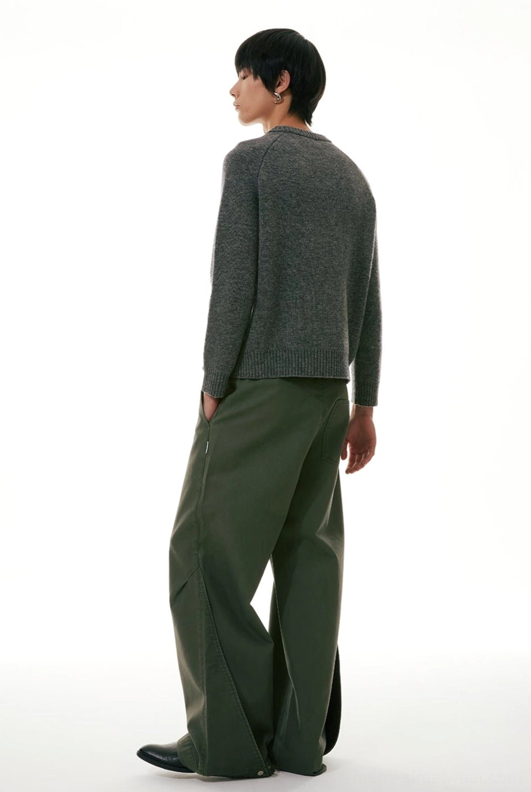 Side back view of relaxed wide-leg workwear denim jeans showing the loose straight-leg silhouette and casual knitwear styling