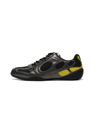 Retro black and yellow colorblock low-profile sneakers shown from the left side with gunmetal grey overlays, black mesh panels, circular cutout details, neon yellow accents, lace-up closure, and front vamp strap