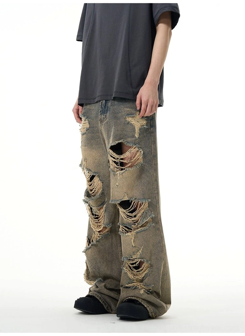Side view of retro blue distressed wide-leg jeans showing loose straight leg and heavy frayed ripped detailing