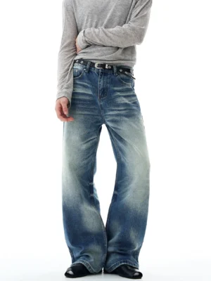 Front full-body view of retro blue glacier fade flare-leg jeans with wide bell-bottom silhouette, vintage washed denim, grey long-sleeve top, black leather shoes, and streetwear styling