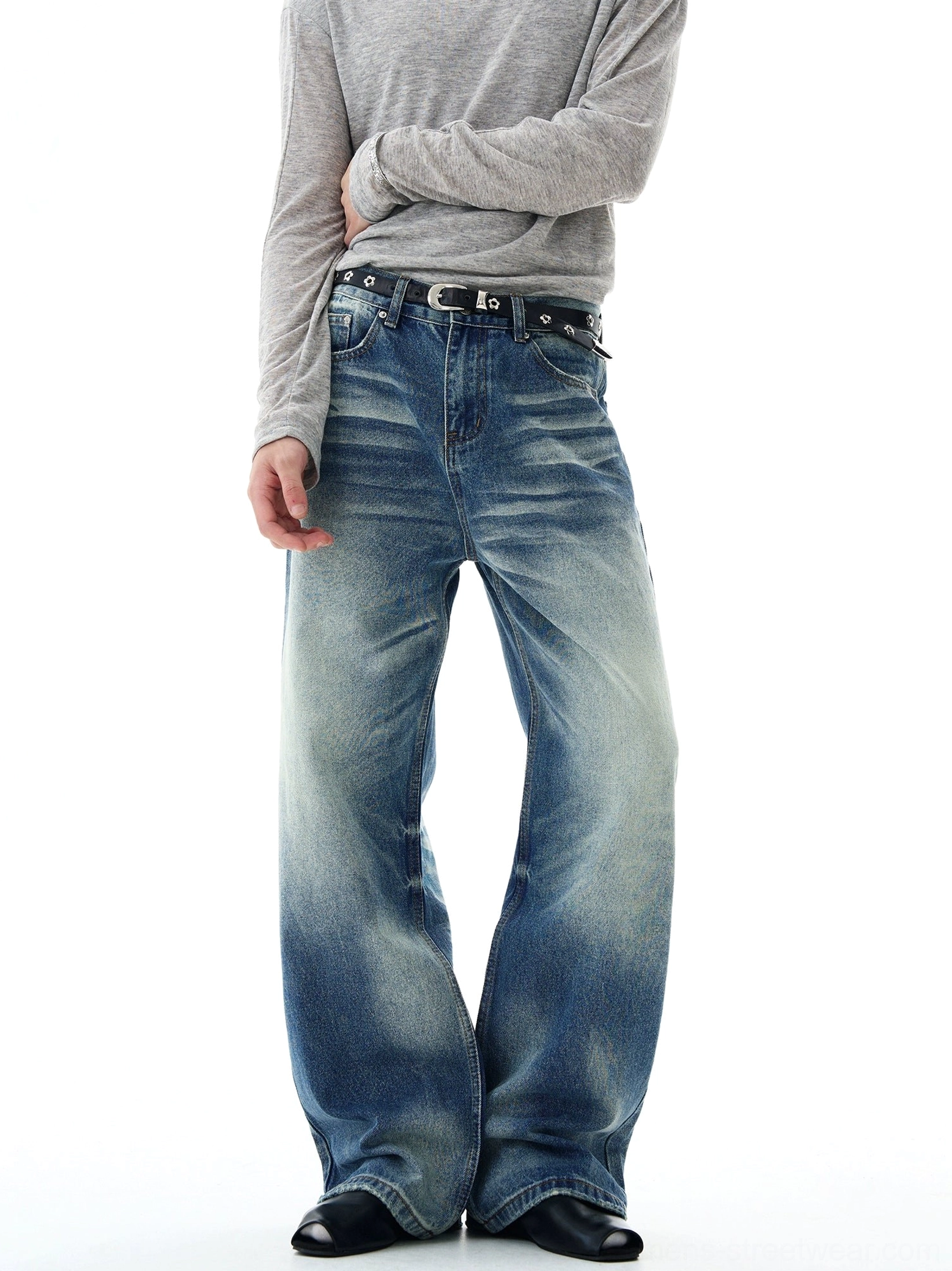 Front full-body view of retro blue glacier fade flare-leg jeans with wide bell-bottom silhouette, vintage washed denim, grey long-sleeve top, black leather shoes, and streetwear styling