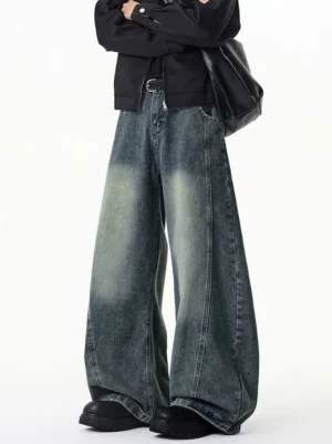 Retro blue gradient washed ultra-wide leg jeans shown from a low-angle front side view with 3D side panels, floor-length denim legs, metal buckle, zipper detail, and black leather shoes