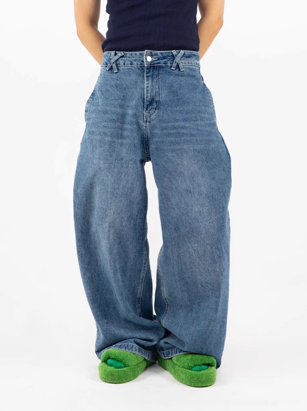 Retro blue puddle denim jeans front full-body view showing oversized wide-leg shape and stacked hems over shoes