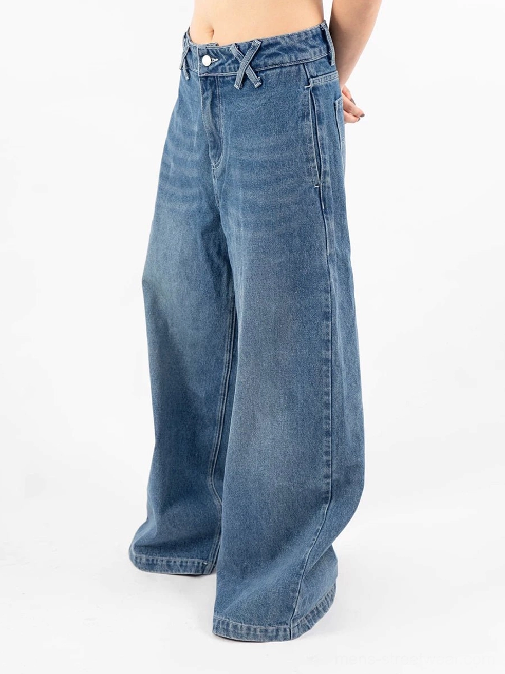 Retro blue ultra wide-leg jeans side view showing folded waistband detail and exaggerated baggy denim leg