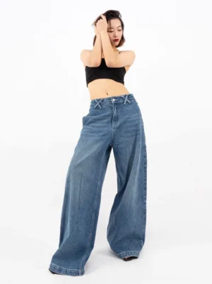 Retro blue ultra wide-leg denim jeans front three-quarter view showing relaxed baggy fit and long pooling hems