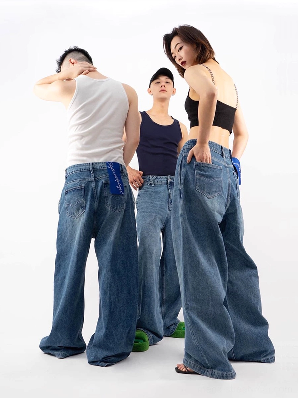 Retro blue ultra wide-leg puddle denim jeans rear group view showing long baggy silhouette and vintage wash