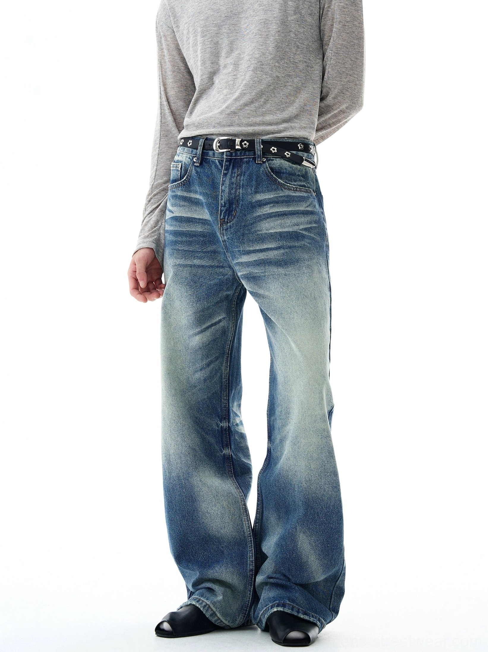 Angled front view of wide-leg flare jeans in faded retro blue denim, showing the mid-rise waistband, relaxed fit, thigh fading, and contemporary Korean streetwear silhouette
