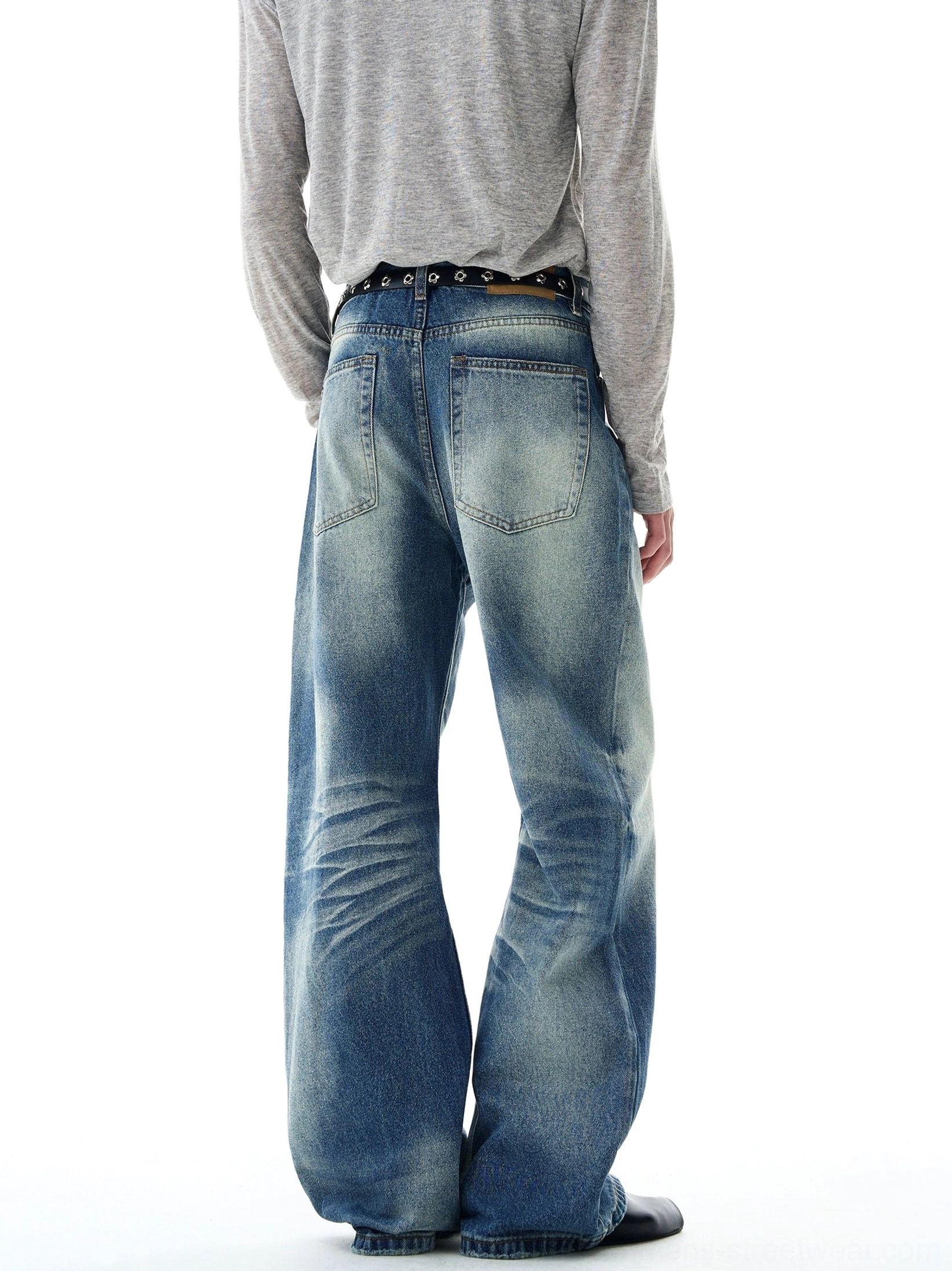 Rear full-body view of retro blue wide-leg jeans featuring classic patch pockets, faded denim panels, relaxed bell-bottom shape, and casual streetwear styling