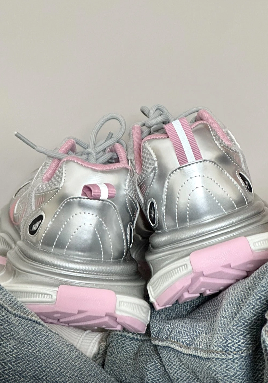 Retro dad sneaker silhouette updated with metallic mesh, structured overlays, and thick technical runner sole