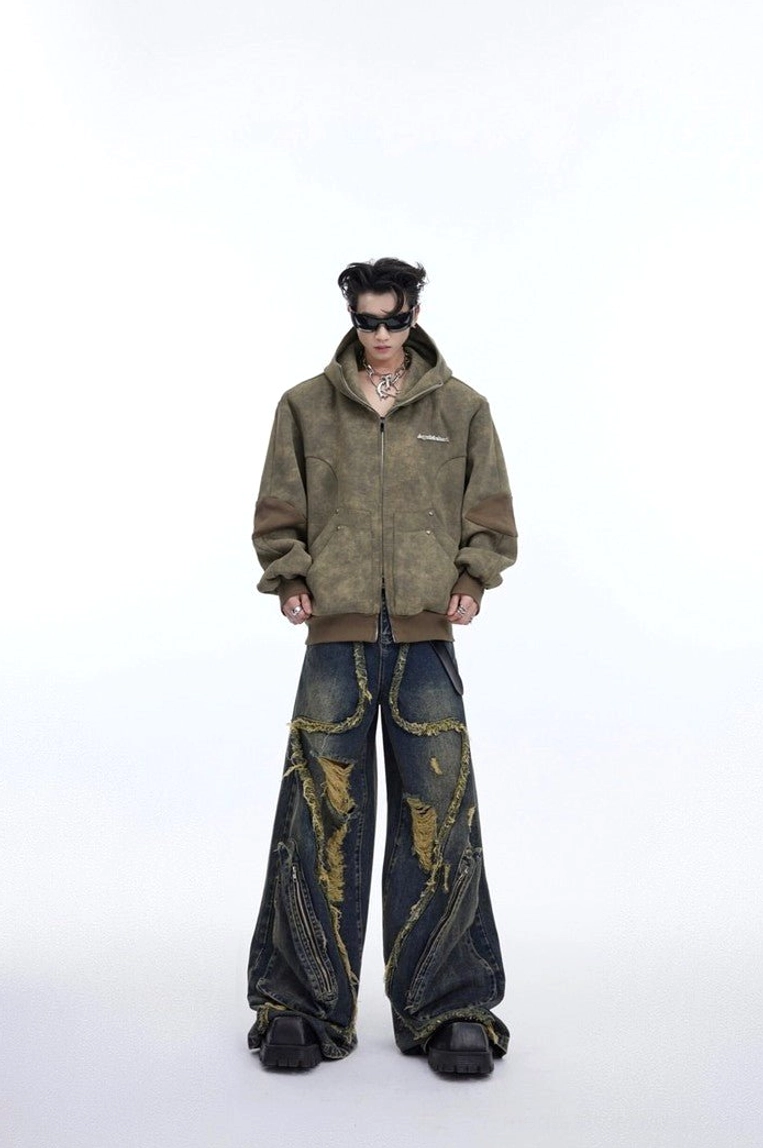 Streetwear outfit featuring vintage blue deconstructed wide leg ripped jeans styled with an olive half zip jacket and sunglasses