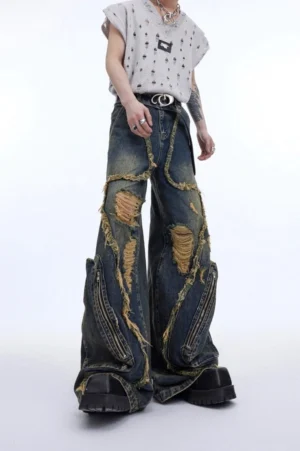 Front full body view of vintage blue retro deconstructed wide leg ripped jeans with frayed seams, distressed cutouts and zipper side pockets